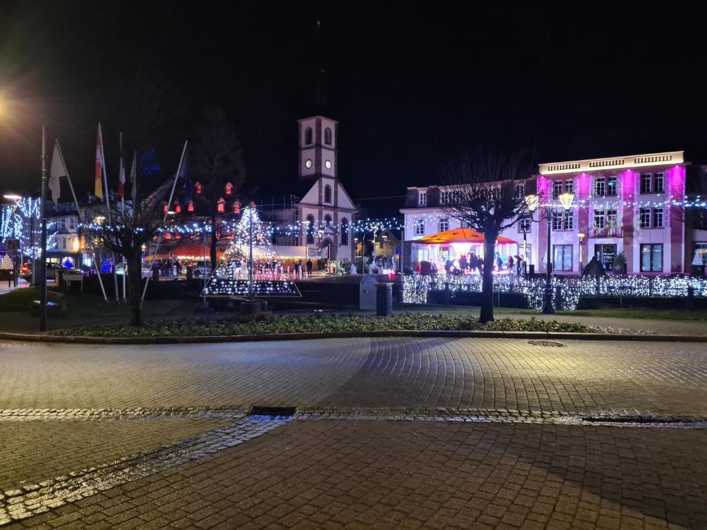 a city lit up at night with christmas lights at Meublé du 25 N°5 de tourisme 3* in Niederbronn-les-Bains