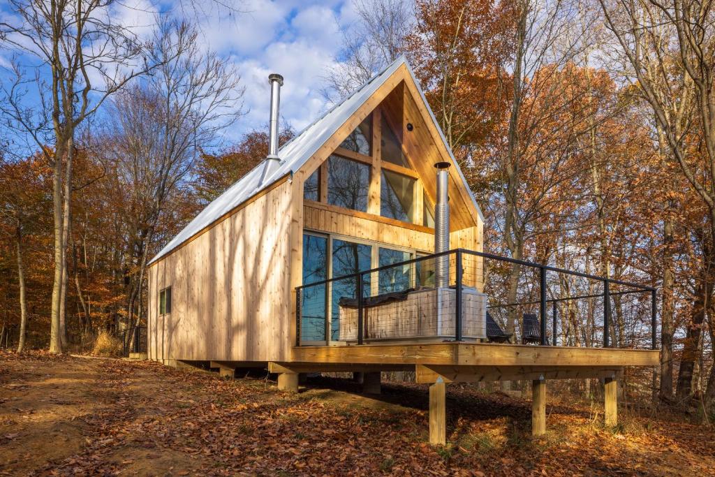 a tiny house on a platform in the woods at The Ffern in Logan