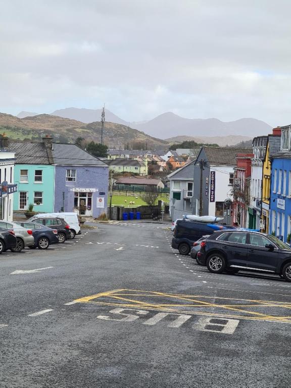 a town with cars parked in a parking lot at Clifden Town Centre Apartment in Clifden