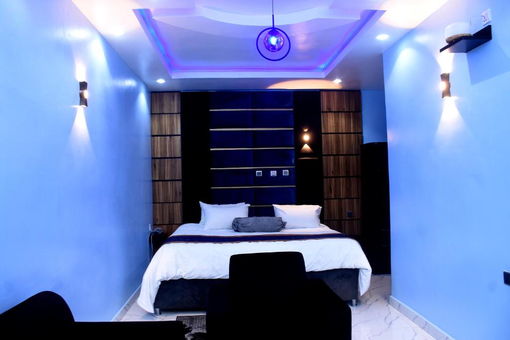 Dreamville Hotel & Resort في أويو: غرفة نوم بسرير مع اضاءة زرقاء