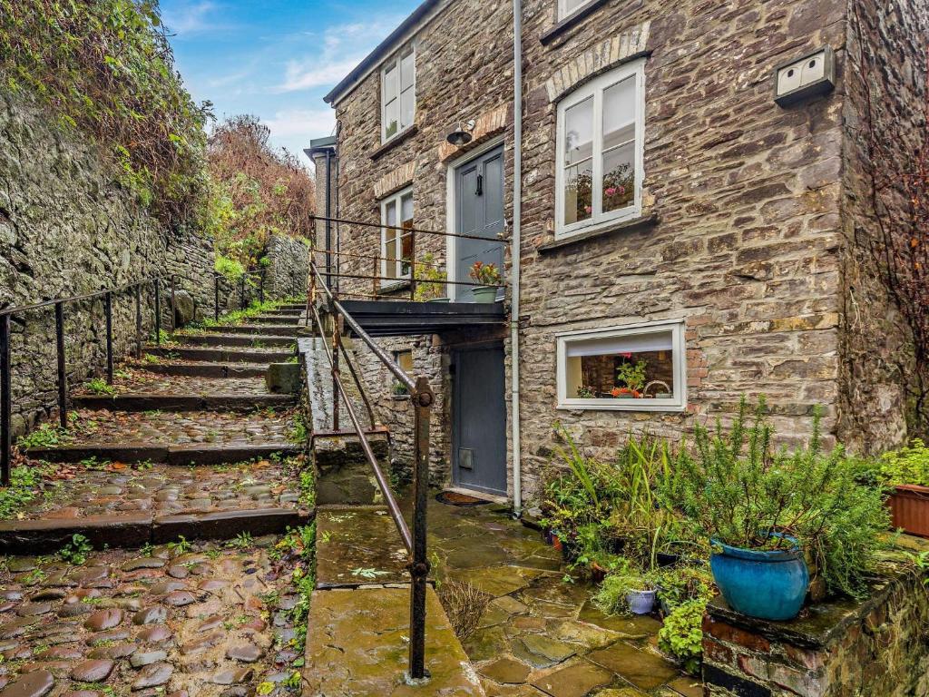 a stone house with stairs leading up to a door at 2 Bed in Brecon 92729 in Brecon