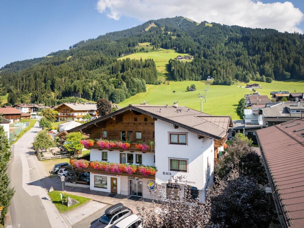 a village in the mountains with a house at Apartment Anita in Westendorf
