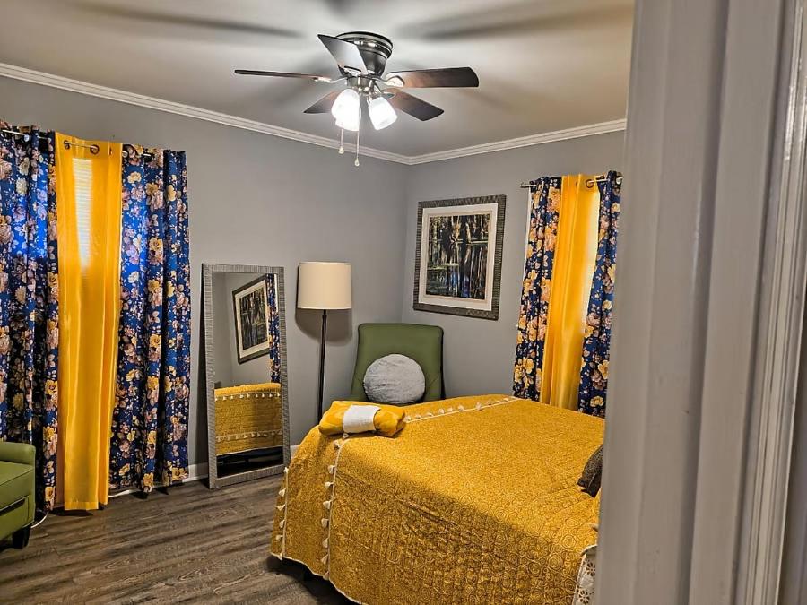 a bedroom with a bed and a ceiling fan at Macon Duplex Getaway | 3BR, WiFi, BBQ & Parking in Riverside Park