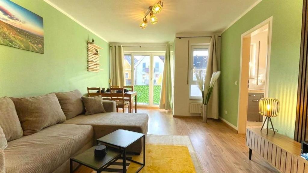 a living room with a couch and a table at Charming accommodation in Radebeul Altkötzenbroda in Radebeul