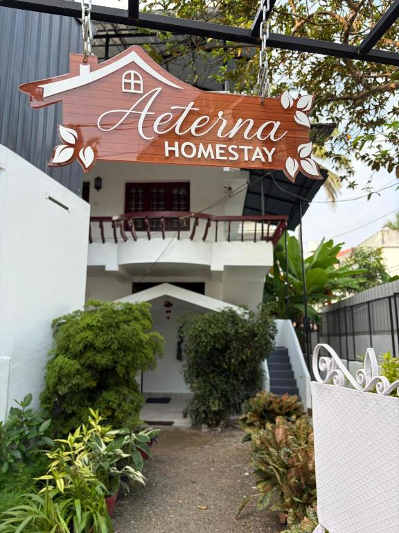 a sign that reads ieriuna homesay hanging from a building at AETERNA Homestay in Fort Kochi
