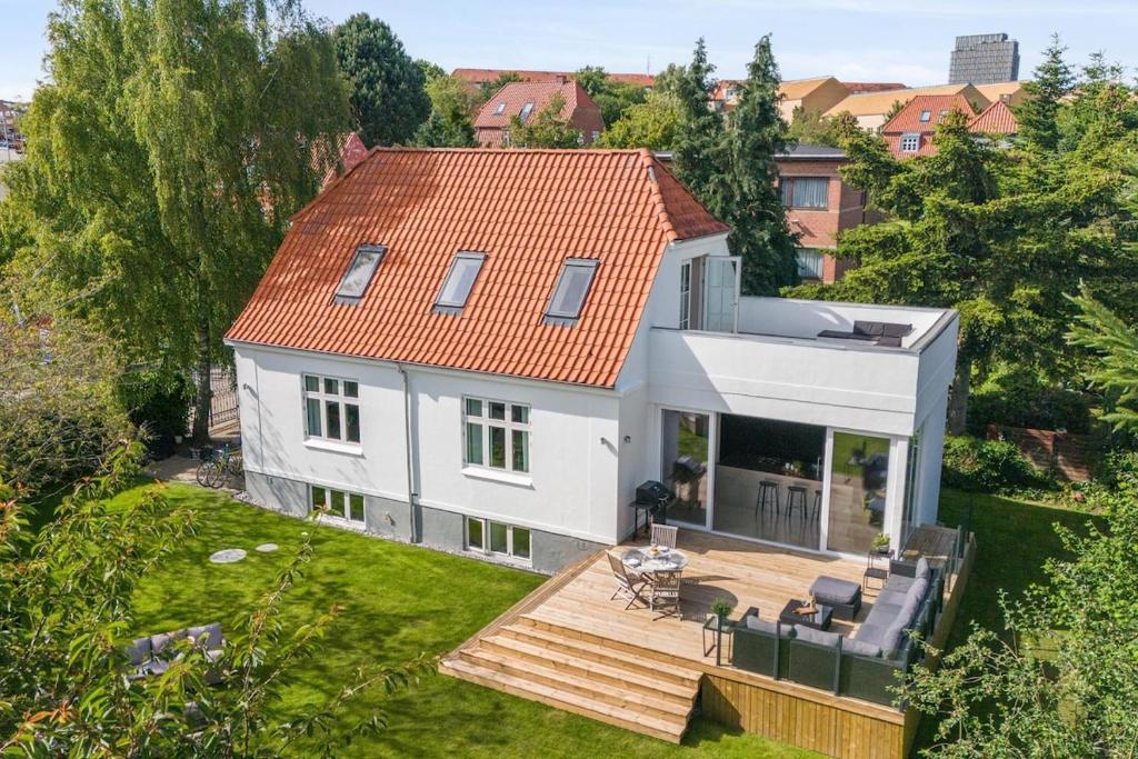 an aerial view of a white house with a deck at Villa in the Heart of Aarhus in Aarhus