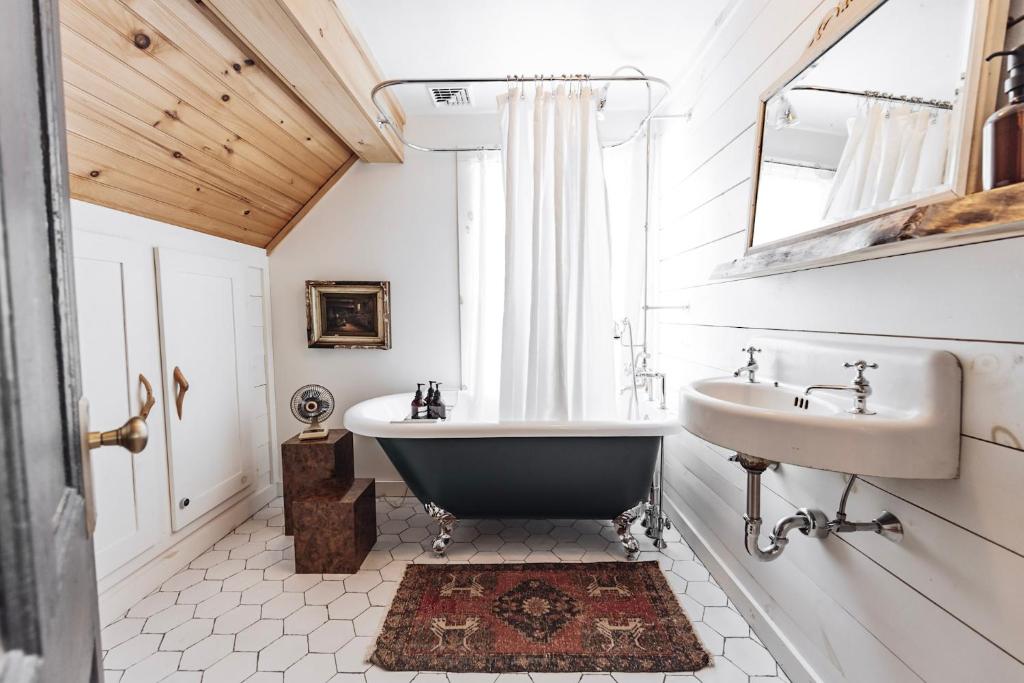 a bathroom with a tub and a sink at Boutique Log Cabin & Two Guest Cabins, Hot Tub, Sauna, Swimming Hole, near Whiteface in Upper Jay