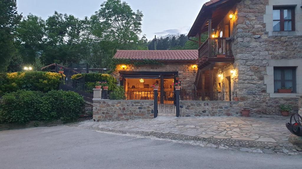 a stone house with a gate in front of it at Casa Caborzal in Renedo