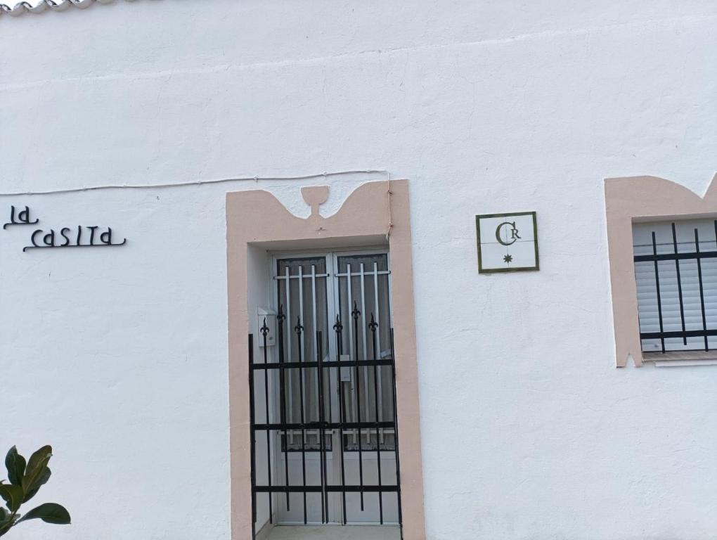 a white building with a gate in front of it at La casita in Medellín