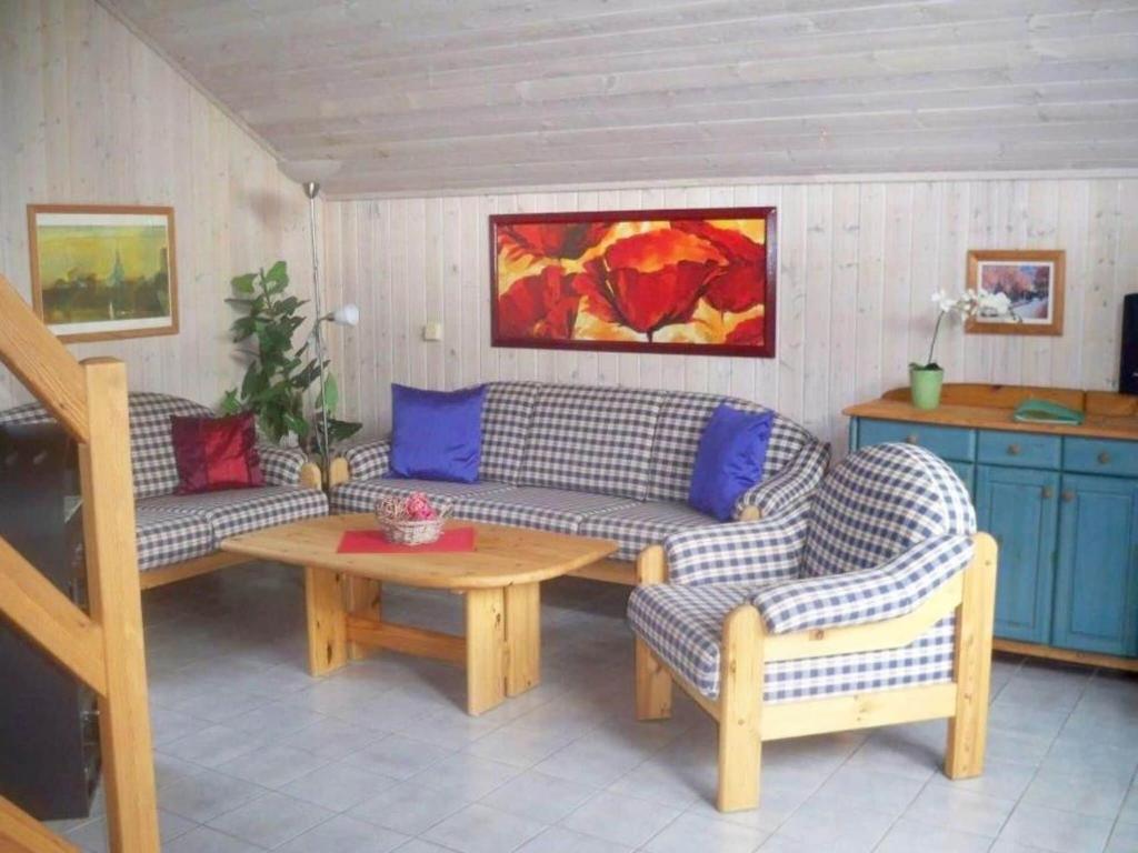 a living room with two couches and a table at Ferienhaus im skandinavischen Stil in Granzow