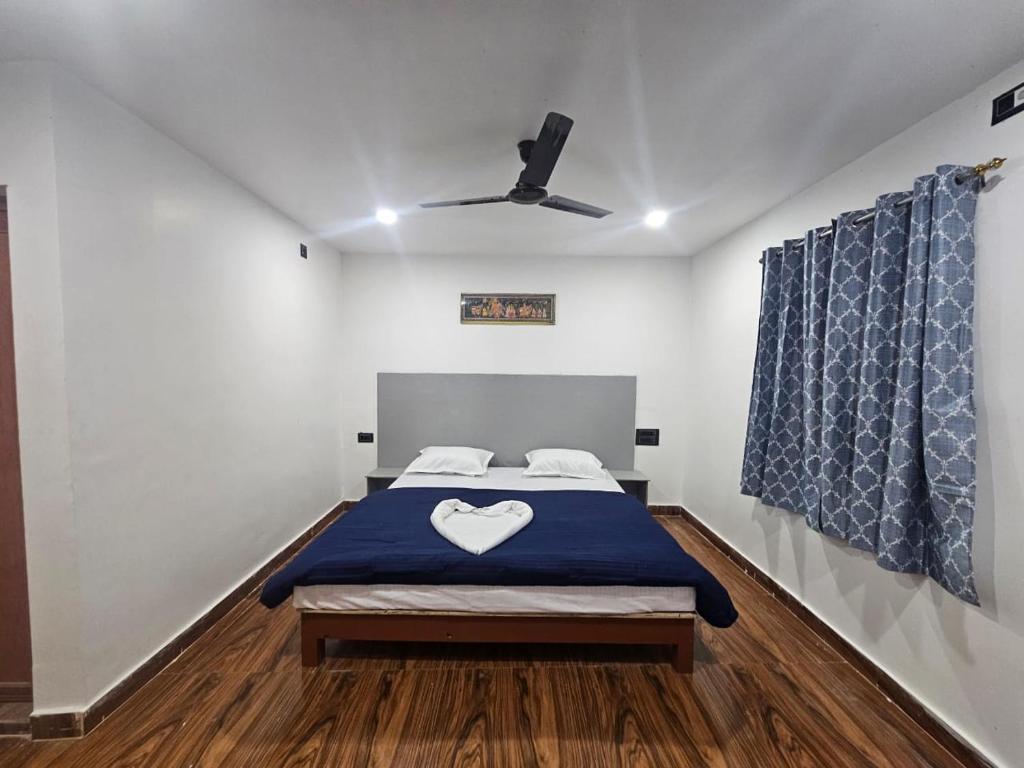 a bedroom with a bed with a heart pillow on it at Mystic Resort Dublagadi in Balasore