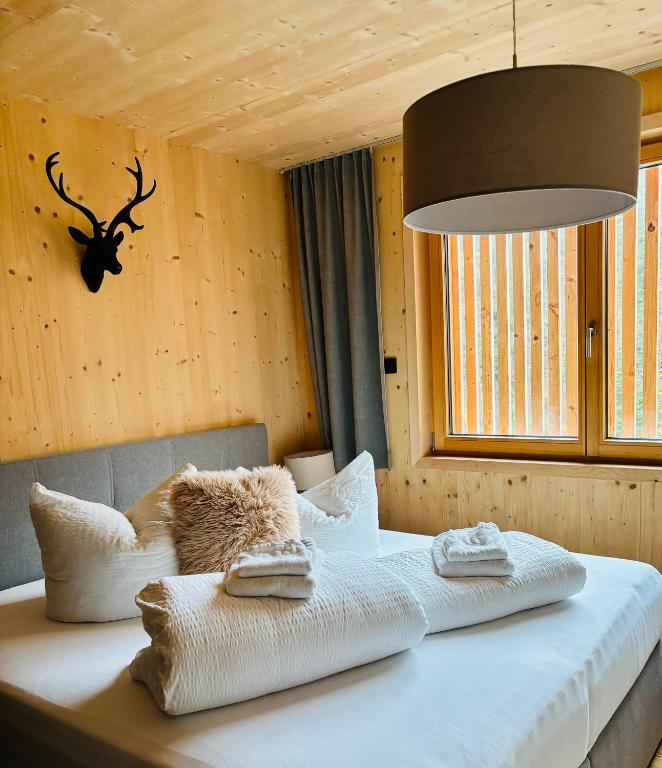 a bedroom with a bed with towels on it at Mellau Apartments in Mellau