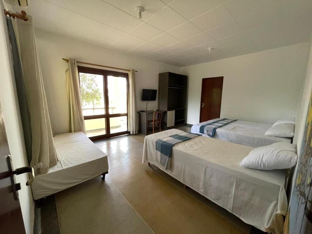 Postel nebo postele na pokoji v ubytování macambira café pousada