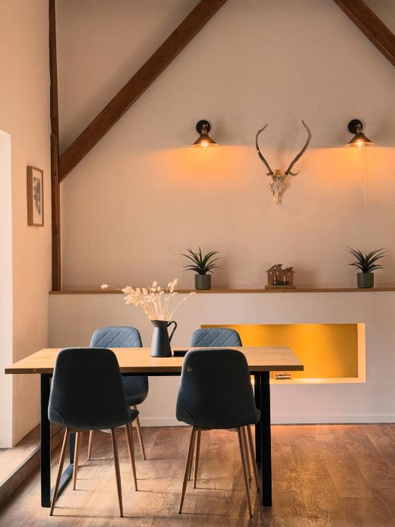 a dining room with a table and four chairs at Alte Scheune in Werneck