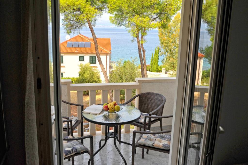 a table on a balcony with a view of the ocean at Apartment Mariner in Sutivan