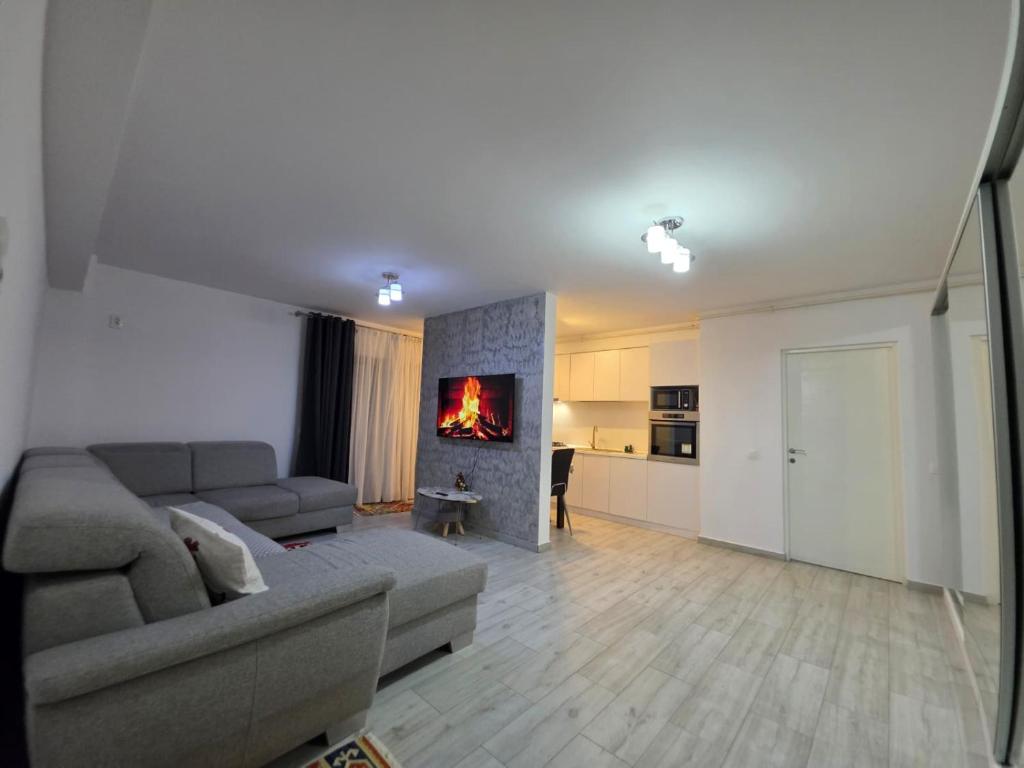 a living room with a couch and a fireplace at Apartament Zen Home in Craiova