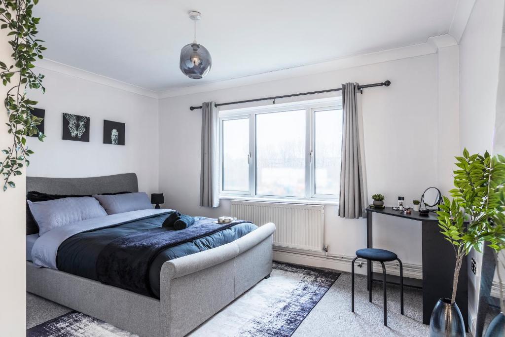 a bedroom with a bed and a window at Stylish Two-Bed Apartment in Ashford in Ashford