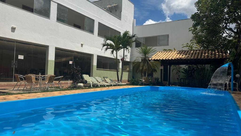 a swimming pool in front of a building at Pousada Cipó in Serra do Cipo