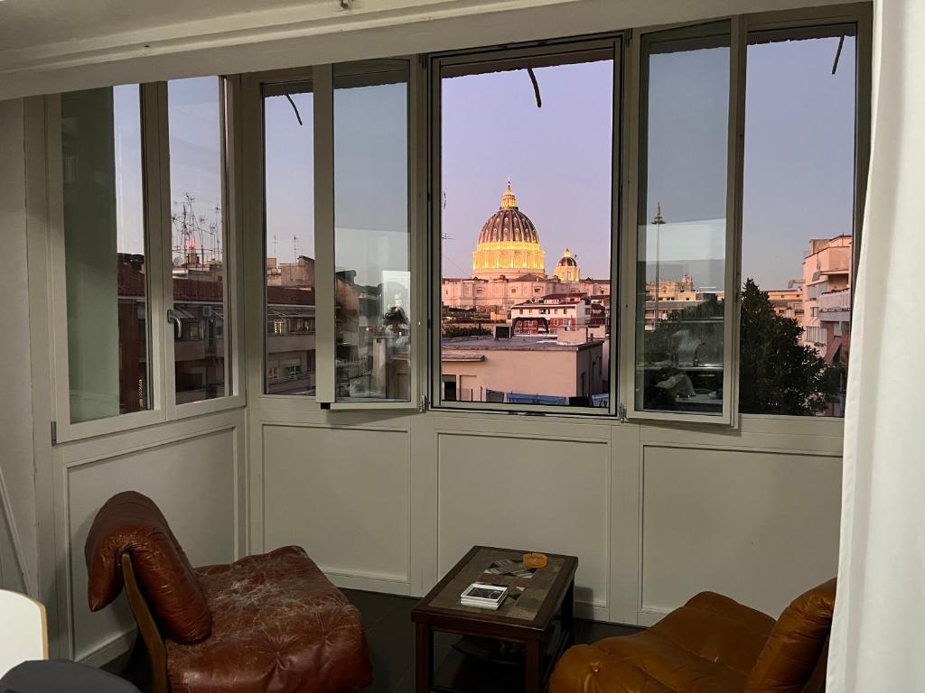 a room with a view of the capitol building seen through windows at St Peter Lodge in Rome