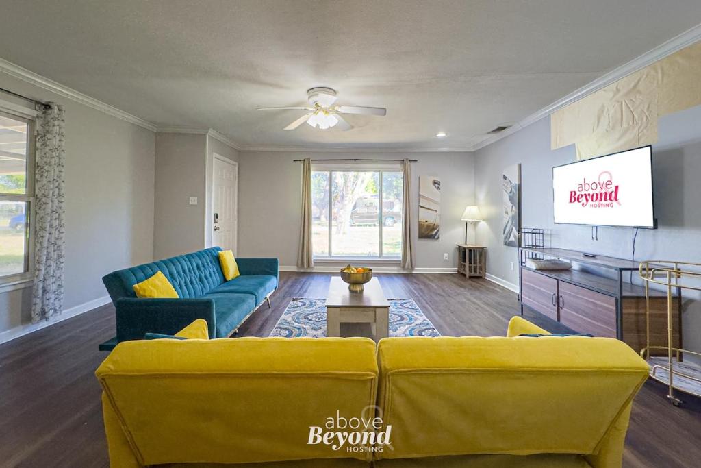 a living room with a couch and a tv at The Updated Aviator - Minutes to Everything Wichita Falls, TX in Wichita Falls