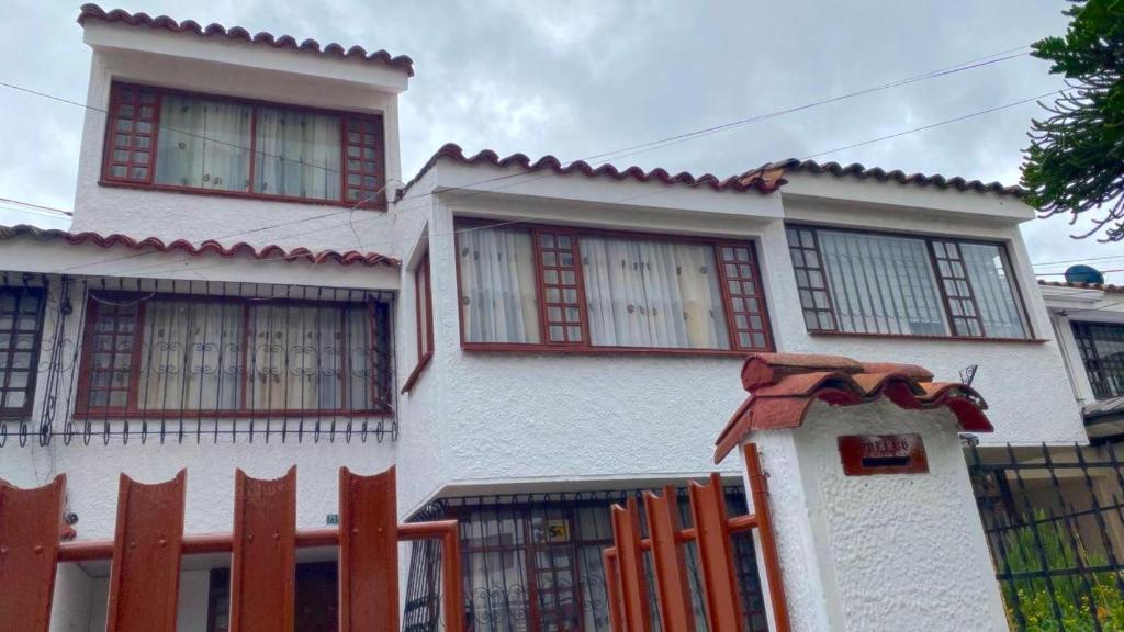 a white house with a fence in front of it at Villa Santa Ines in Bogotá