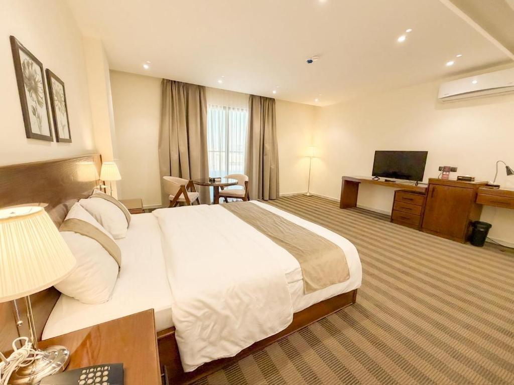 a hotel room with a large bed and a television at North paradise hotel in Irbid