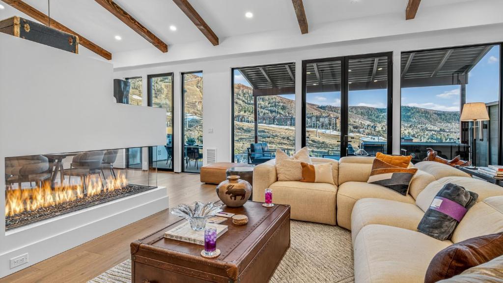a living room with couches and a fireplace at Crescendo Crest in Steamboat Springs