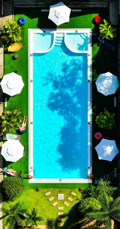 an overhead view of a swimming pool with umbrellas at SunzEn Palawan, Resort in Coron