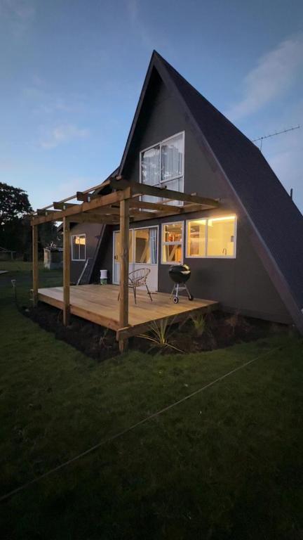 a house with a large deck in the yard at Awhina's Lodge in Ohakune