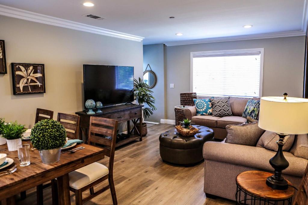 a living room with a couch and a tv at Destination #37 in Fullerton