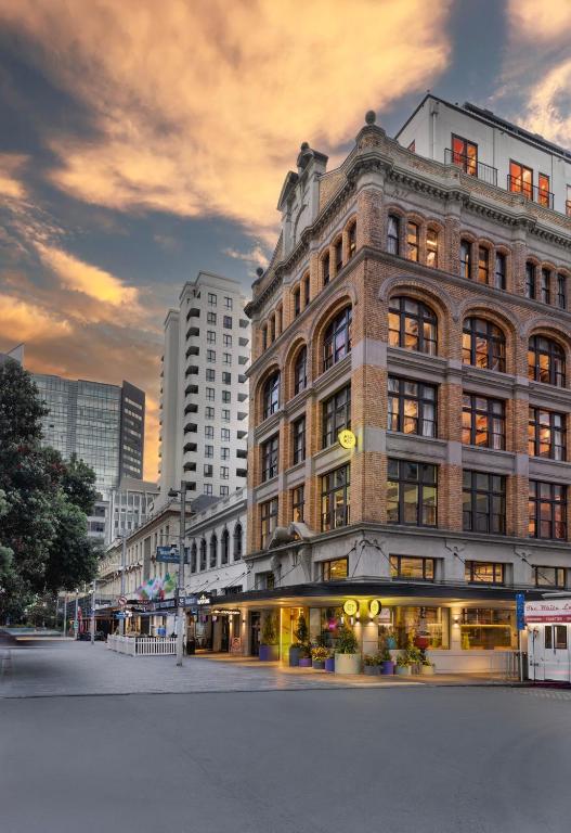a large brick building in front of a city at JO&JOE Auckland in Auckland
