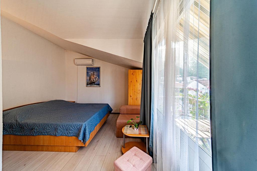 a bedroom with a bed and a large window at Studio Trpanj 257c in Trpanj