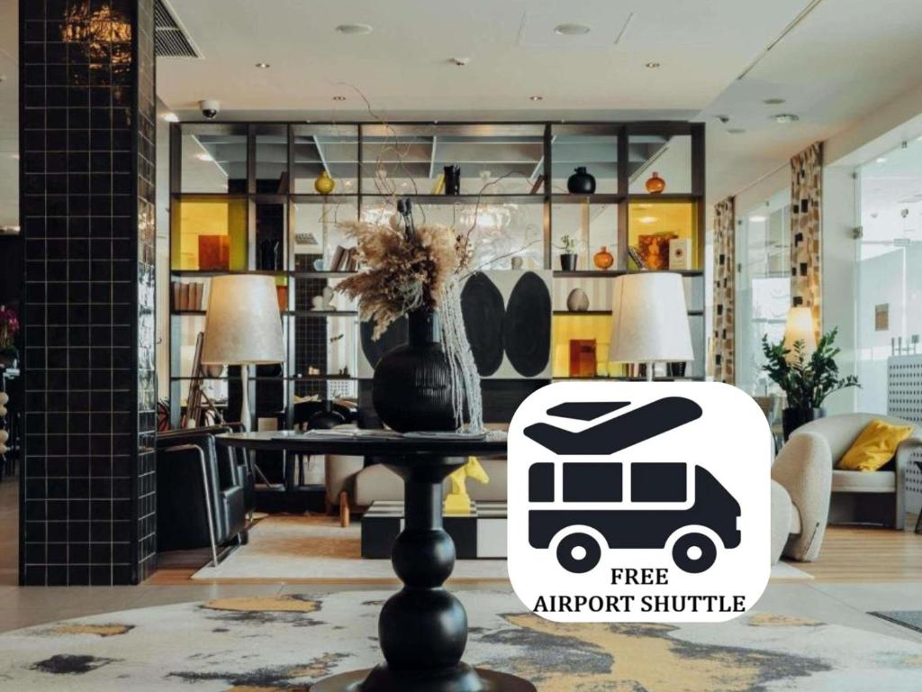 a free airport shuttle sign on a table in a living room at ibis Styles Warszawa Airport in Warsaw
