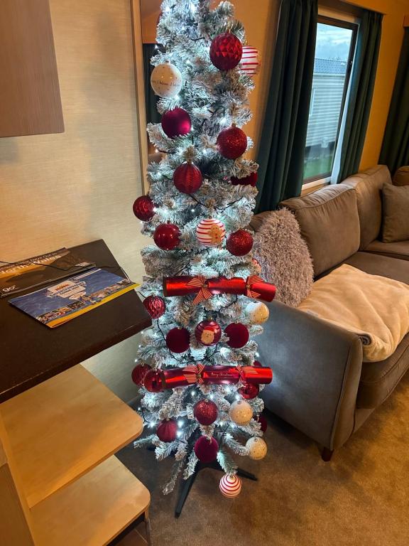 a silver christmas tree in a living room at The Willerby Salsa in Rhyl