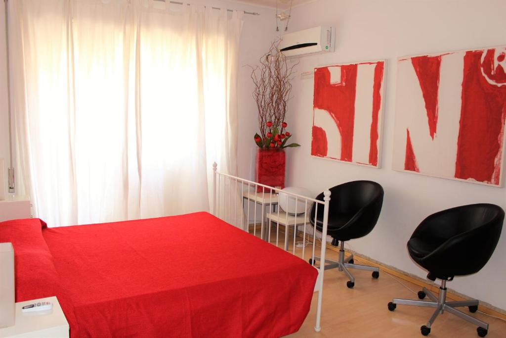 a room with a red table and two chairs at Good House in Vatican in Rome