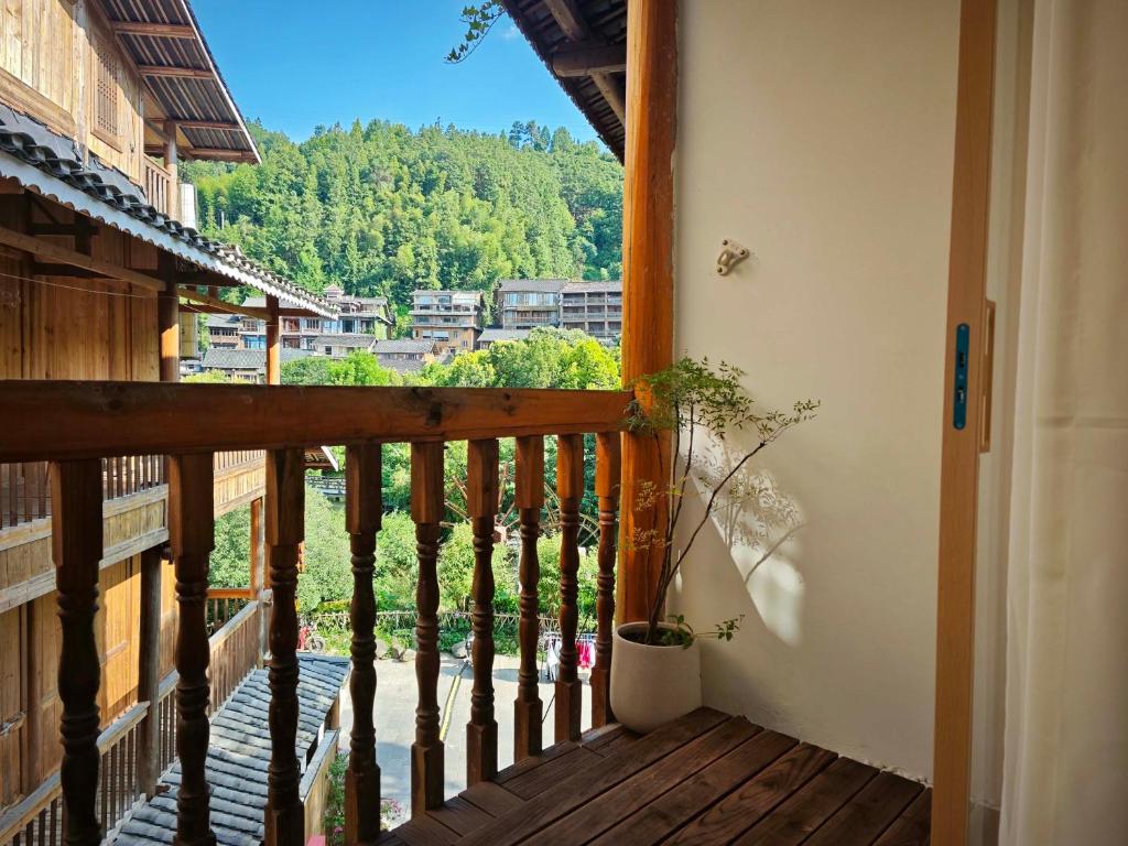 a balcony of a house with a view at Miwu Homestay in Liping