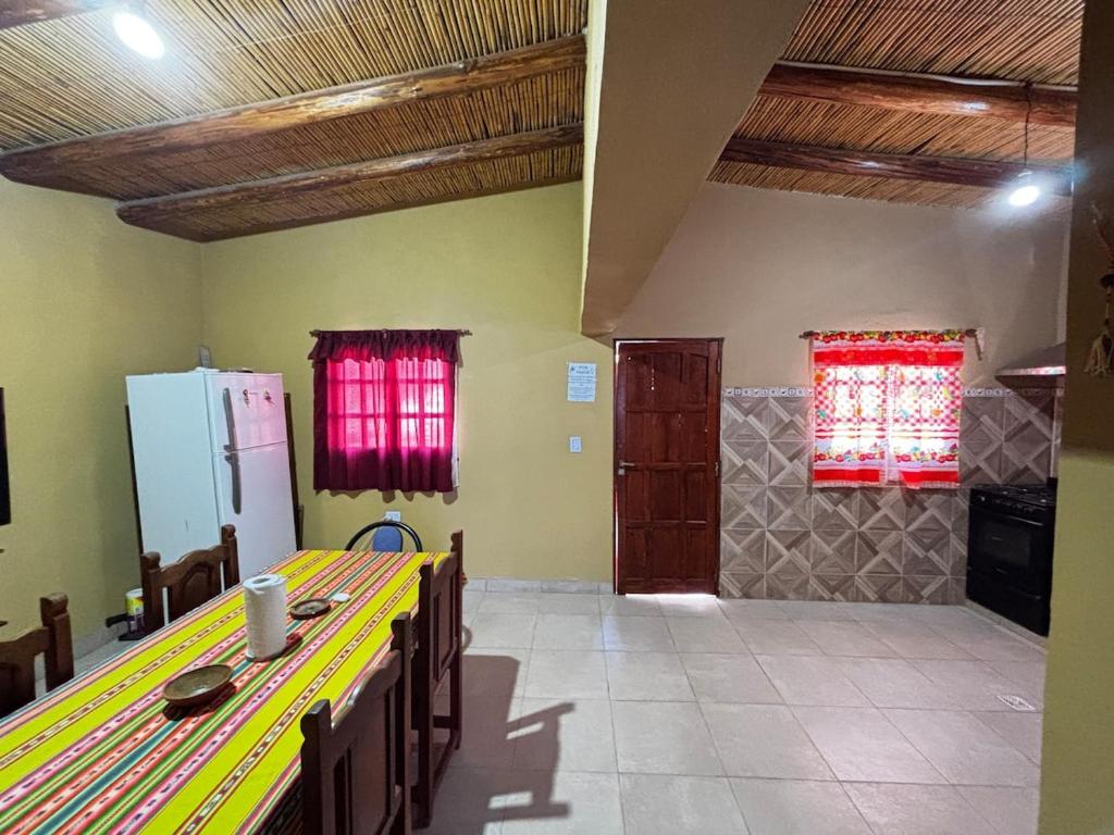 a kitchen with a table and chairs in a room at Alojamiento Tati in Purmamarca