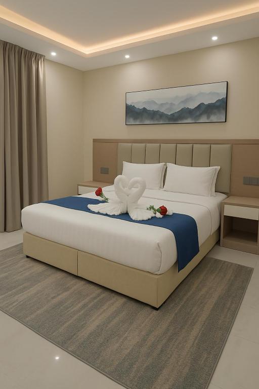 a bedroom with a large bed with flowers on it at فندق الضيافة in Rawkhah