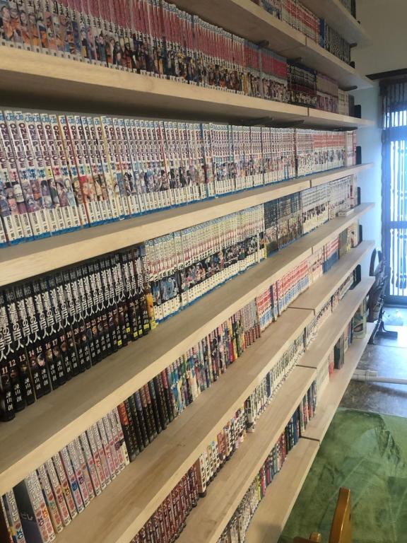 a shelf full of dvds in a store at 漫画のある家 in Wada
