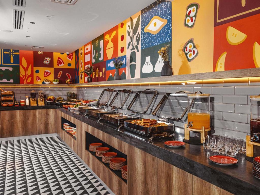 a buffet line with food on display in a restaurant at ibis Tbilisi City in Tbilisi City