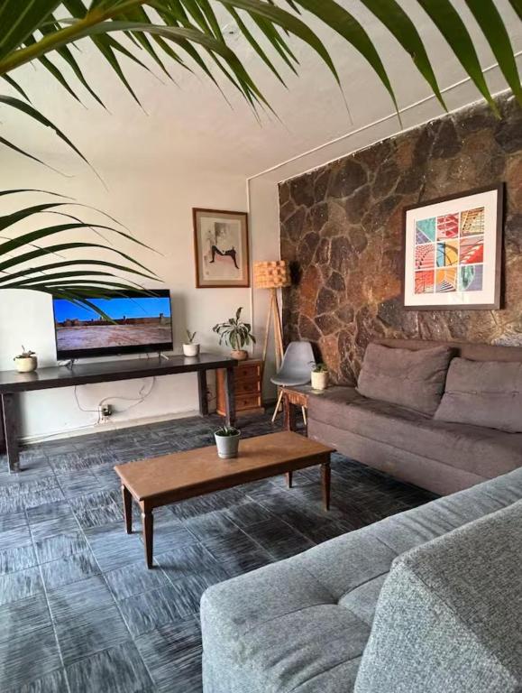 a living room with a couch and a table at Hostal Casa Herrera in Guadalajara