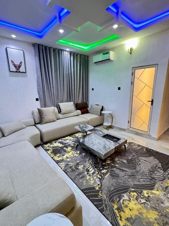 a living room with a couch and a table at Wii Apartments and Suites in Mama