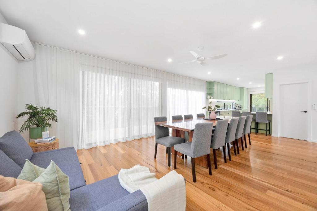 a dining room and living room with a table and chairs at Gully & Tide in Aireys Inlet