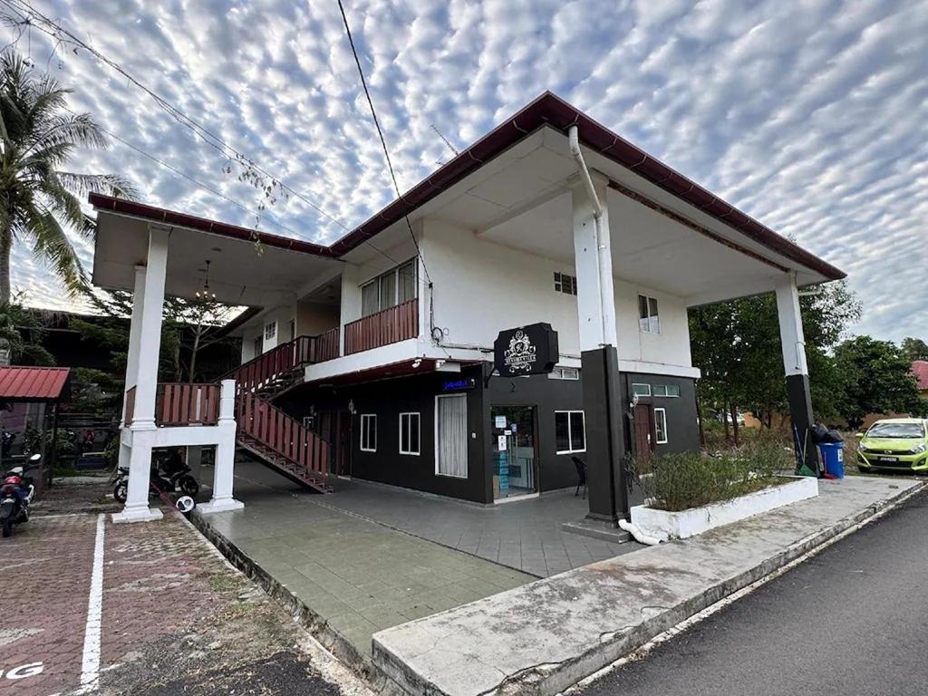 a building with a parking lot in front of it at Kesuma Villa Exclusive Stay in Parit Raja