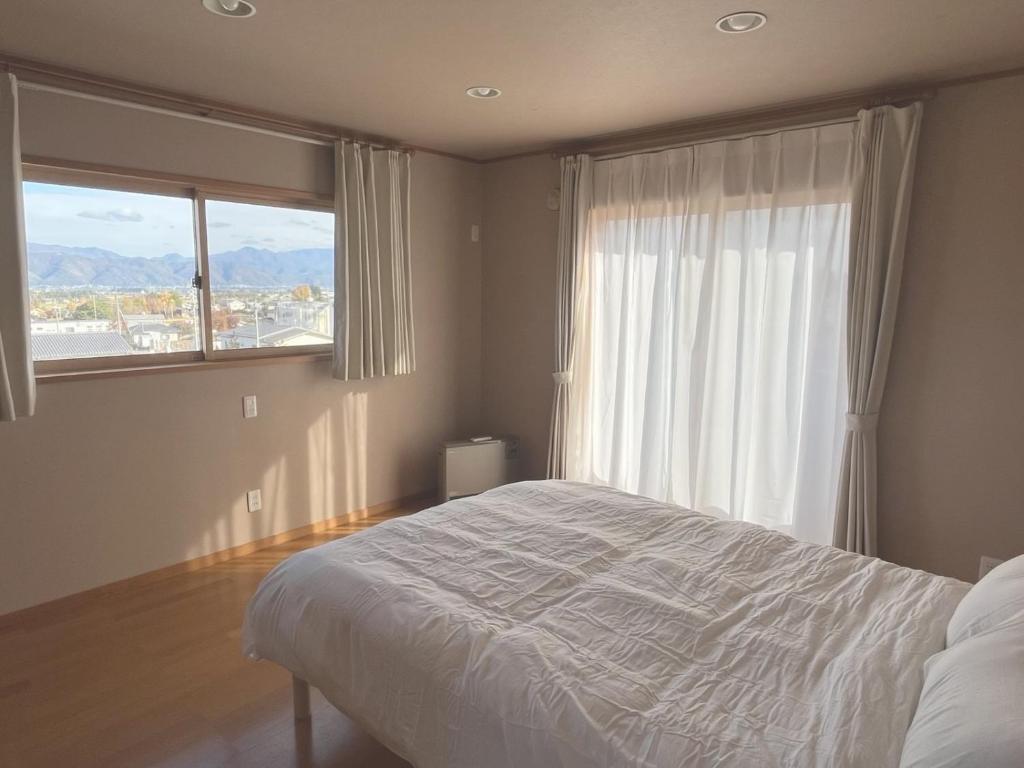 Ένα ή περισσότερα κρεβάτια σε δωμάτιο στο Cozy House Azumino