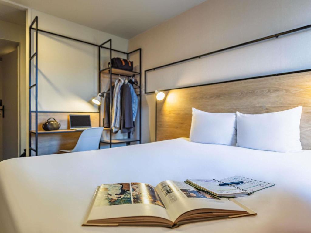 a book sitting on top of a bed at ibis Metz Centre Cathedrale in Metz