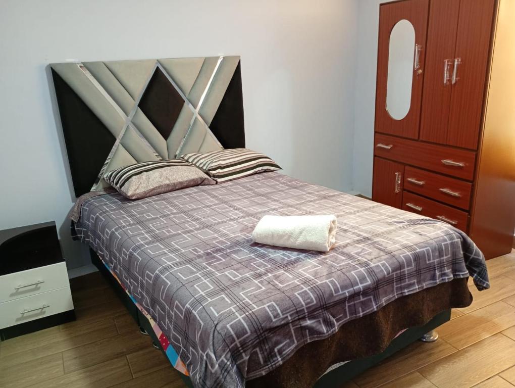a bedroom with a bed with a blanket at Departamento AQP in Arequipa