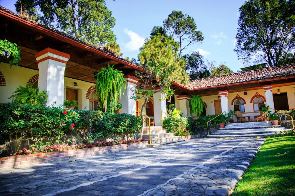 a house with a cobblestone driveway at Regis Hotel Spa in Panajachel