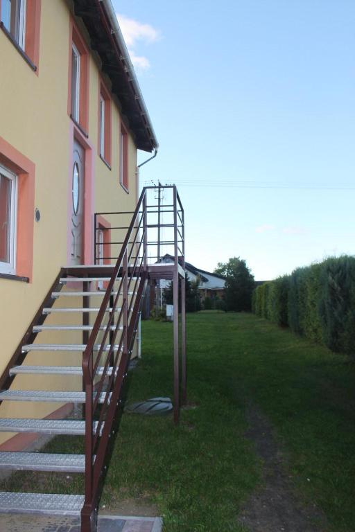 a set of stairs leading up to a building at Wakacyjny Apartament in Karwieńskie Błoto Pierwsze