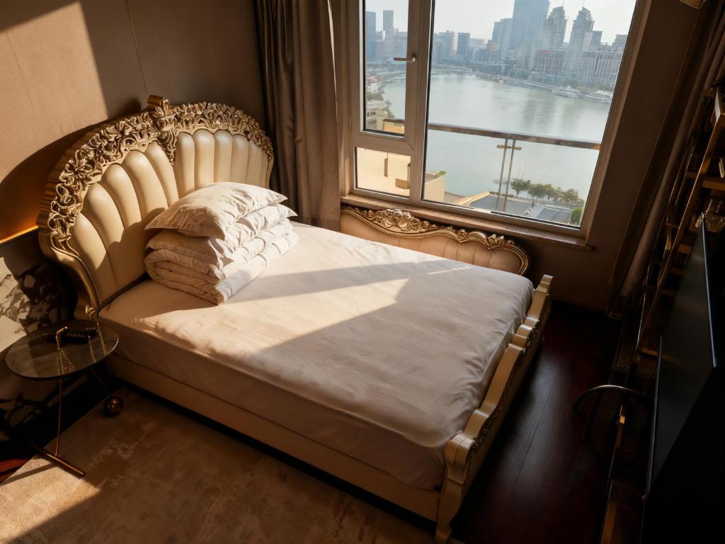 a bed in a room with a large window at Panoramic views of the Bund and the Yangtze River, adjacent to the Oriental Pearl Tower, a top-tier luxury residence in Shanghai in Shanghai